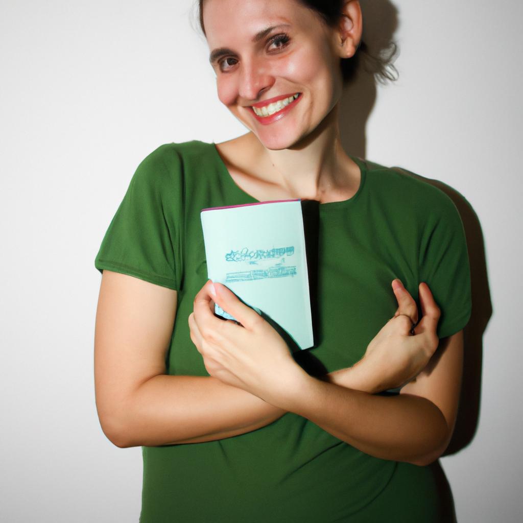 Person holding a book, smiling